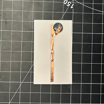 Then, I attached a piece of tape and folded it over so it could touch the battery.