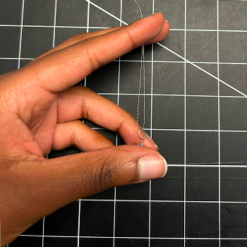 I wanted to create a jewelry piece. I began by looping the thread through the light.