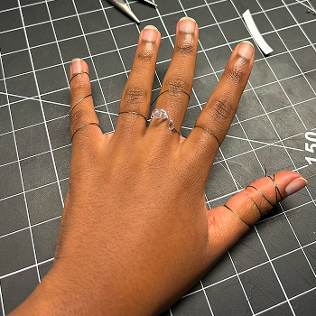 I positioned the light on my middle finger and looped the thread around my fingers.