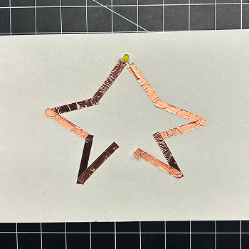 I taped down the light and then put more pieces of tape down to create the rest of the star.